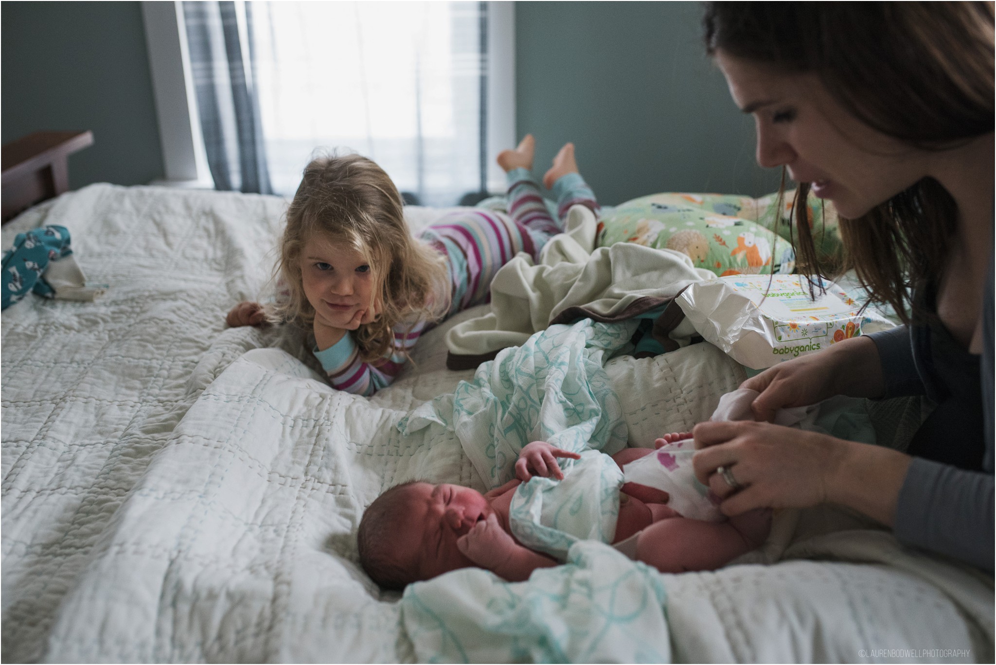 Mom and babies on the bed