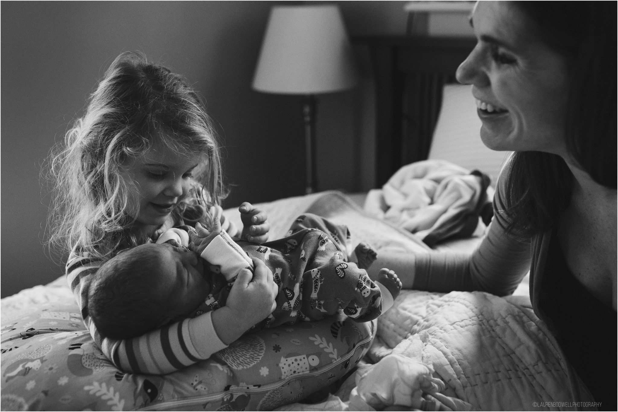 Big sister holding baby brother