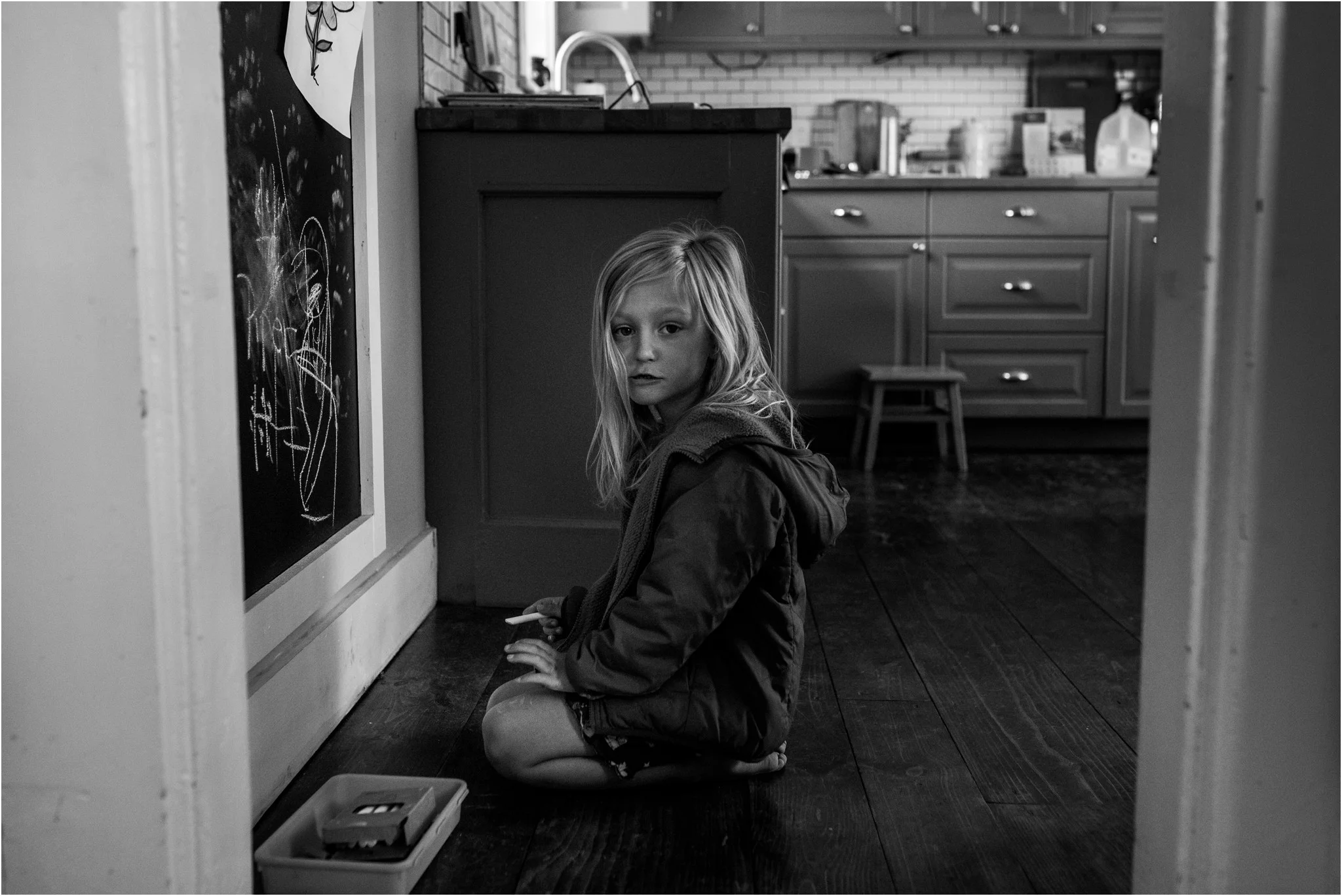 Girl kneeling on the kitchen floor