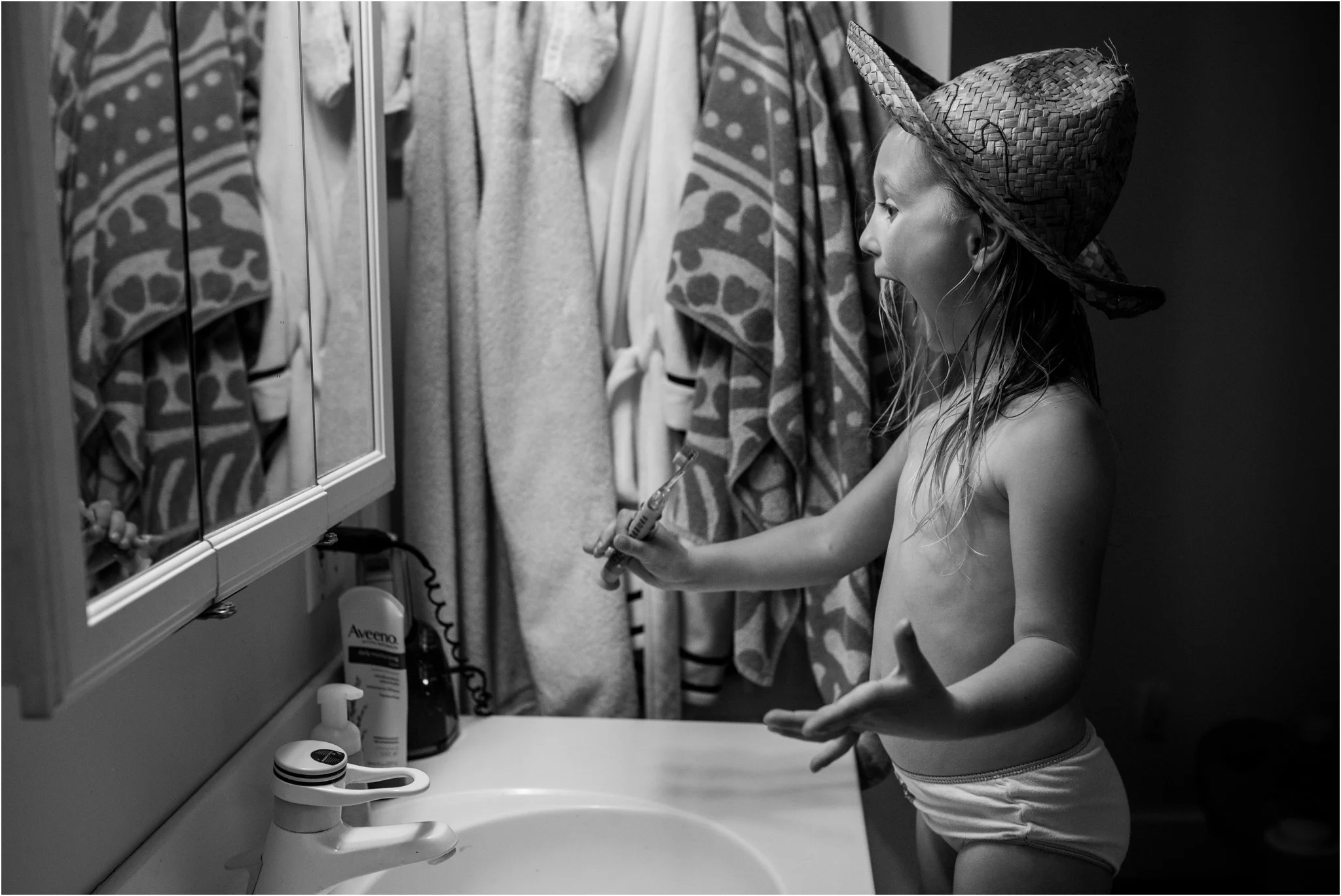 Girl wearing a hat while brushing her teeth