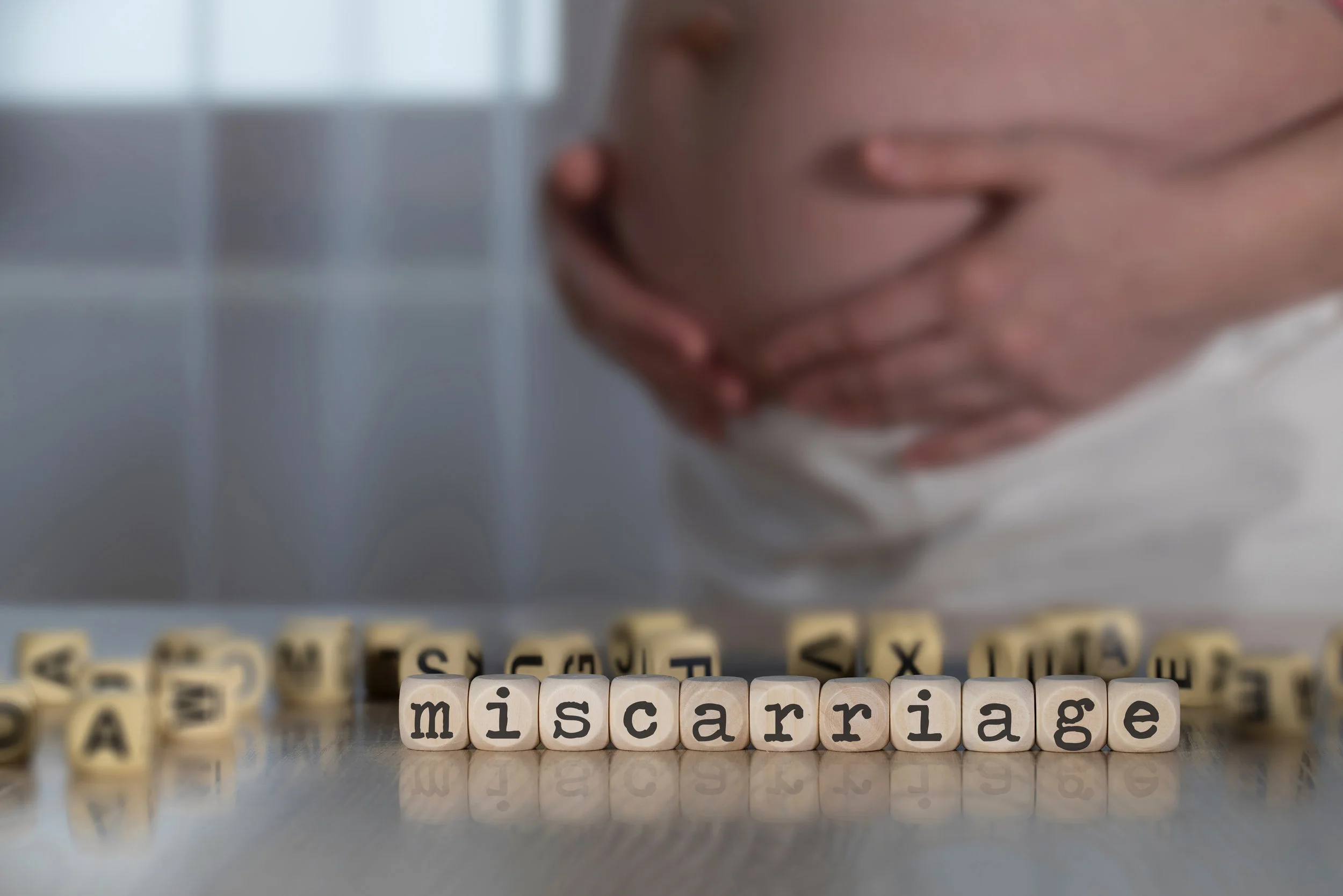 Canva - Word MISCARRIAGE composed of wooden letters..jpg