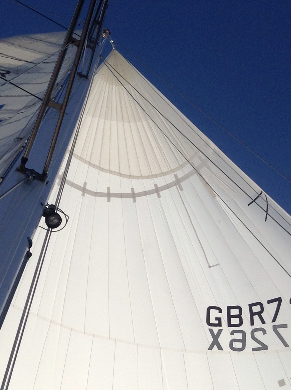 Frankensnoz (repaired and somewhat scarred spinnaker) holds up under light air conditions.