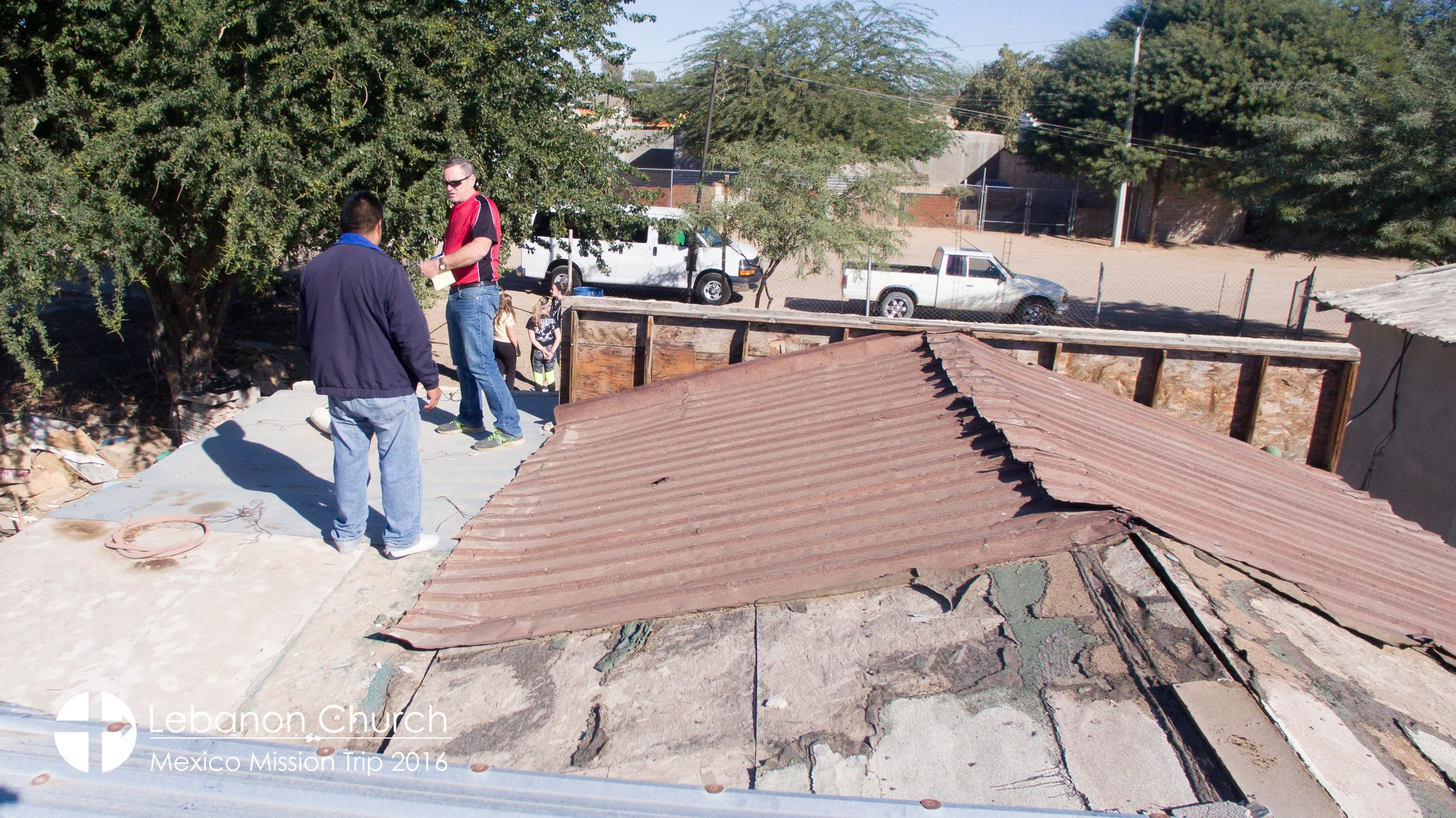 Marcelo and dave taking measurements on guadalupe's roof