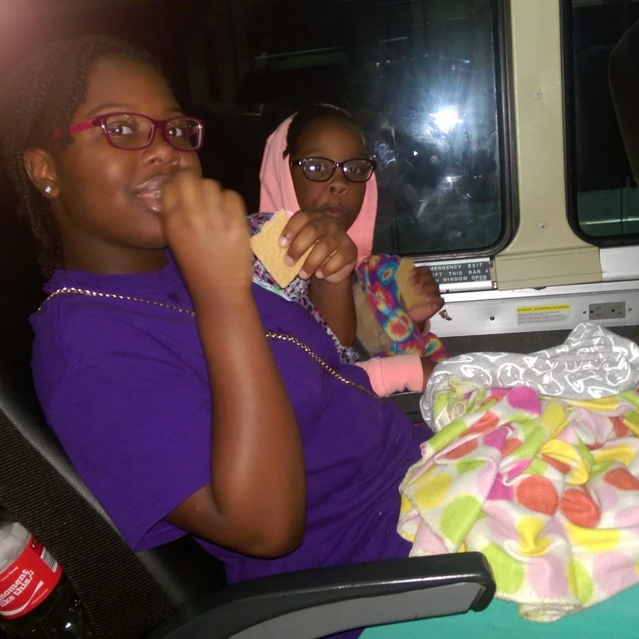 The girls munching on snacks as we head west on the midnight bus.