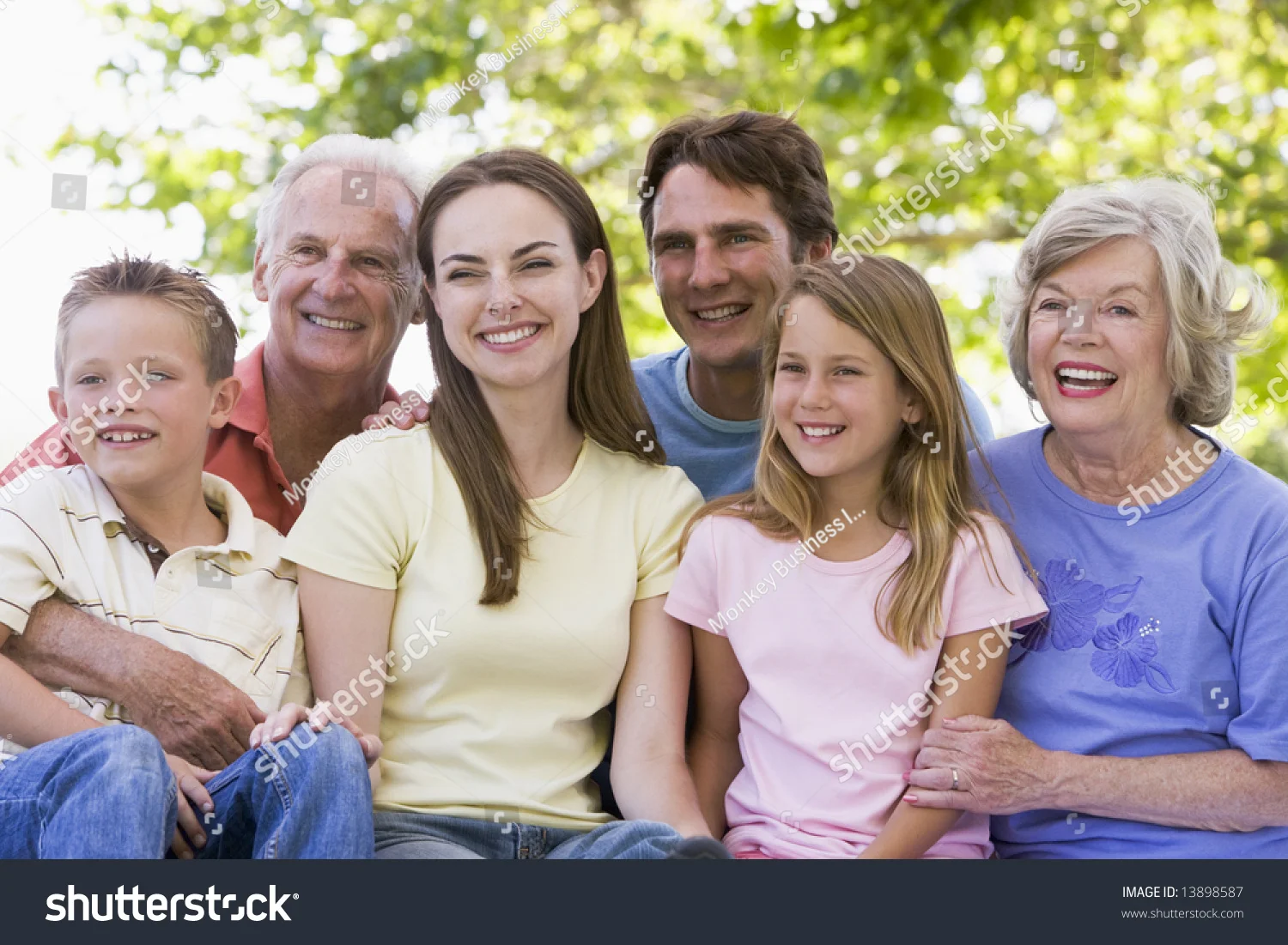 stock-photo-extended-family-sitting-outdoors-smiling-13898587.jpg