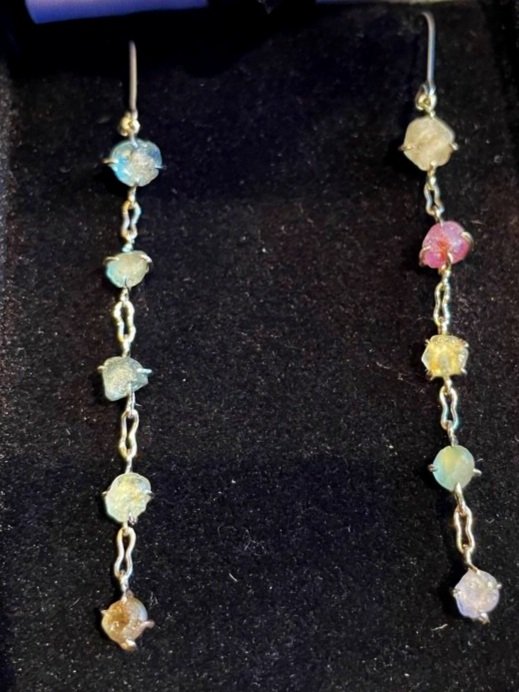  Multi colored uncut Montana sapphires cascading set in white gold. 