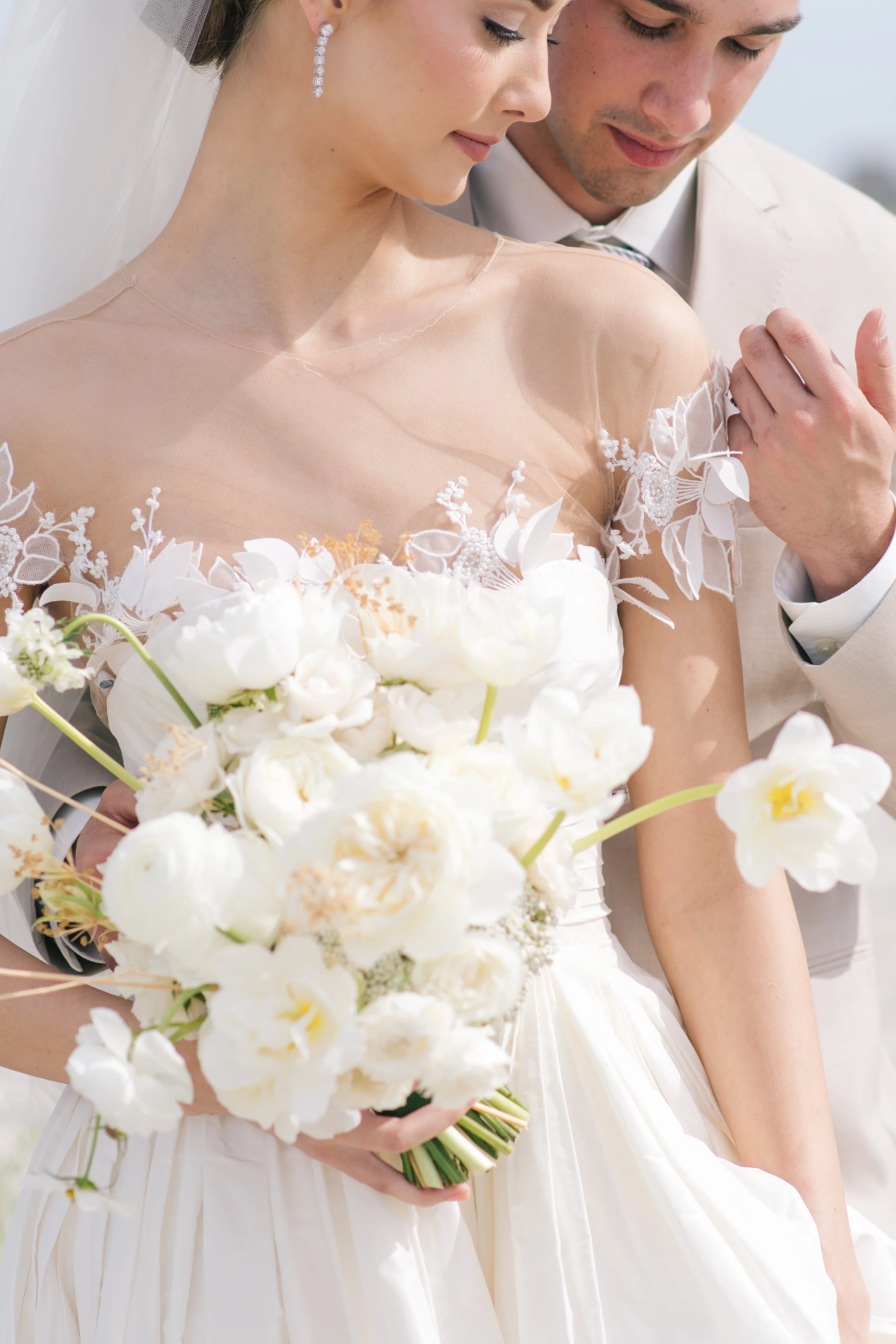 Fine art wedding photography showcasing an elegant bride and groom with white floral bouquet