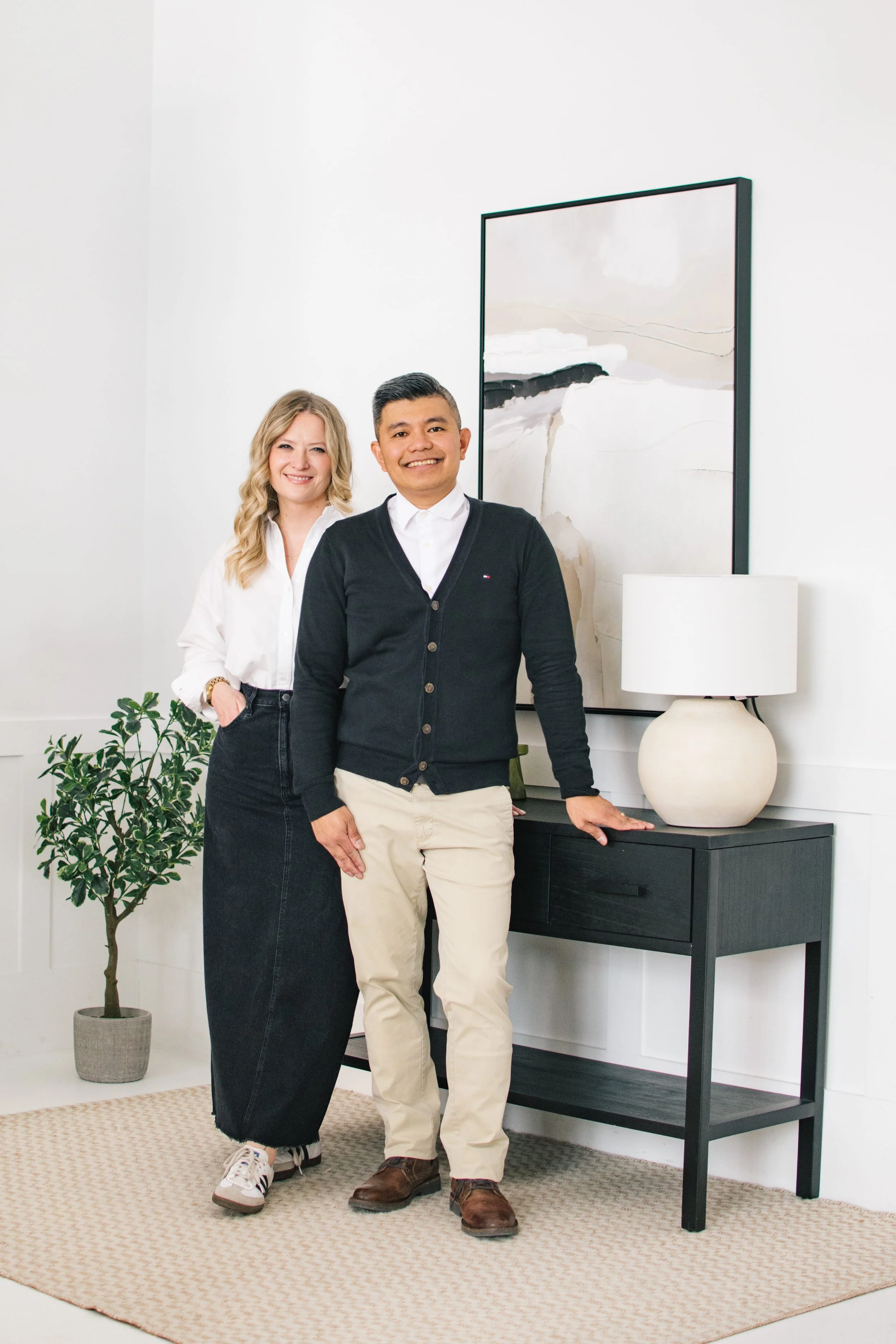 Luxury wedding photography team posing together in a bright, modern studio