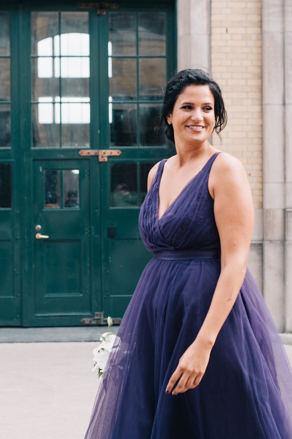 A candid photograph of a bridesmaid on a Toronto's couple wedding day