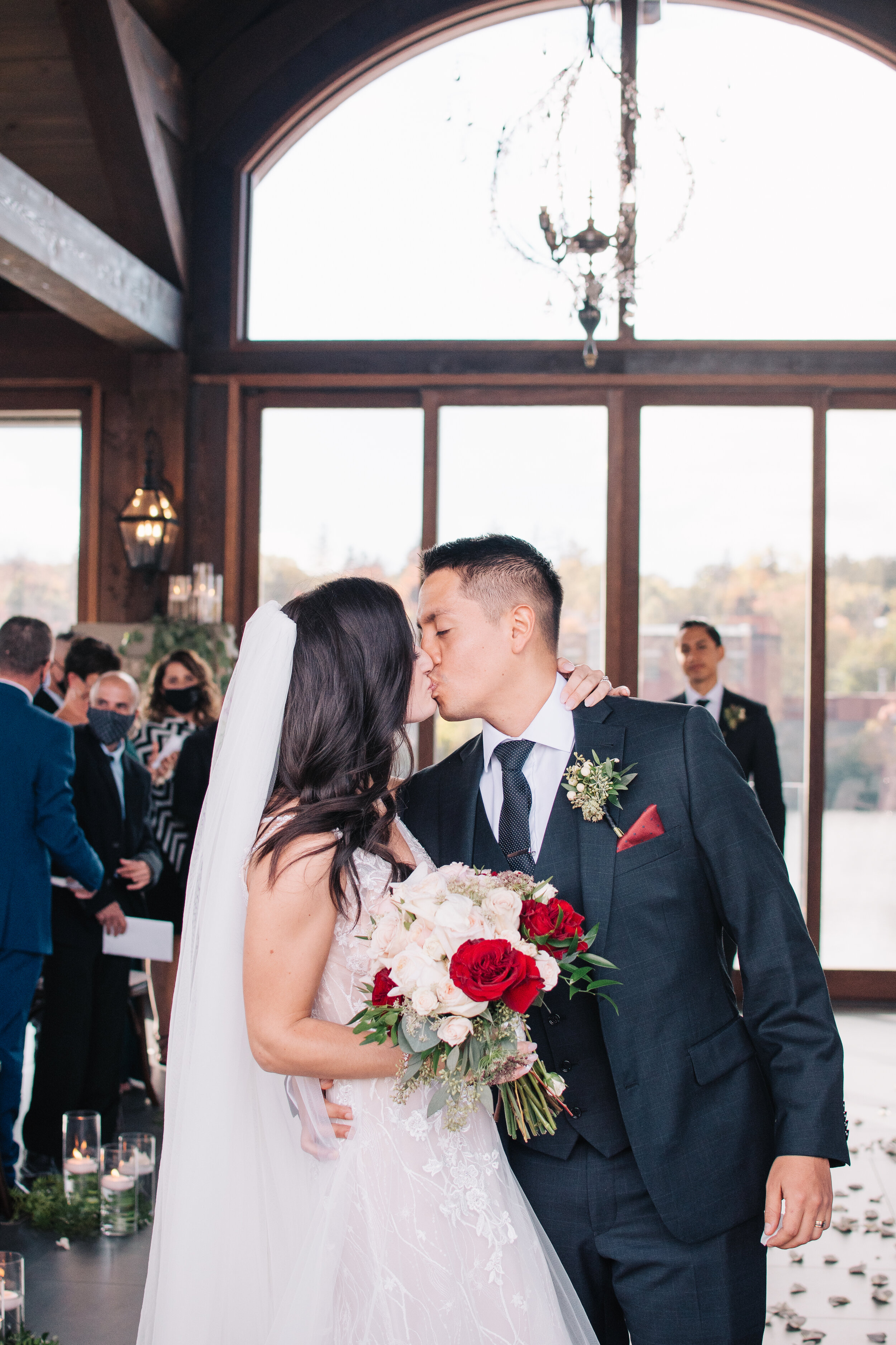 Bride and groom's first kiss as husband and wife photographed by Toronto wedding photographers, Ugo Photography