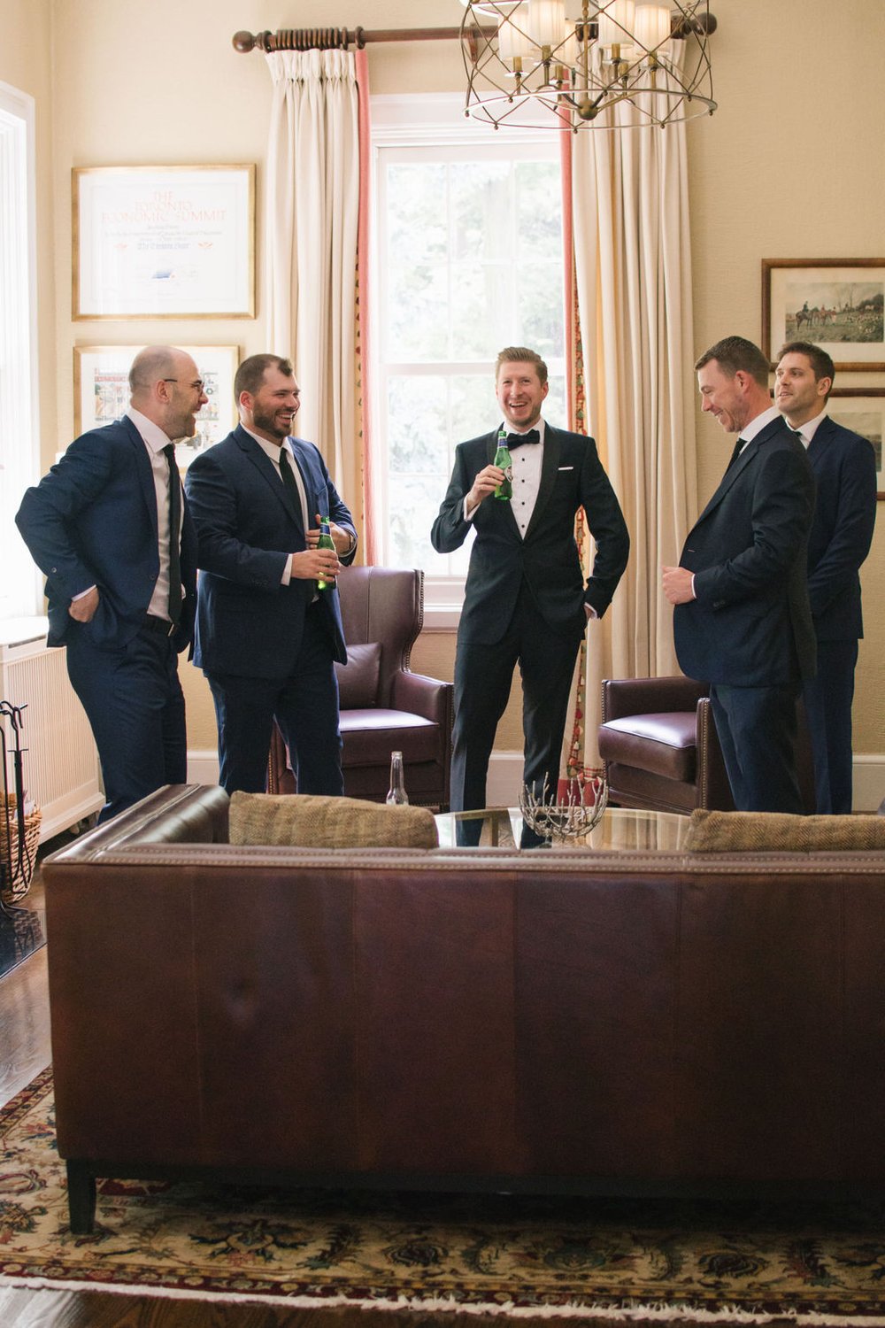 Joyous candid moment with the groom and his groomsmen at The Toronto Hunt Club