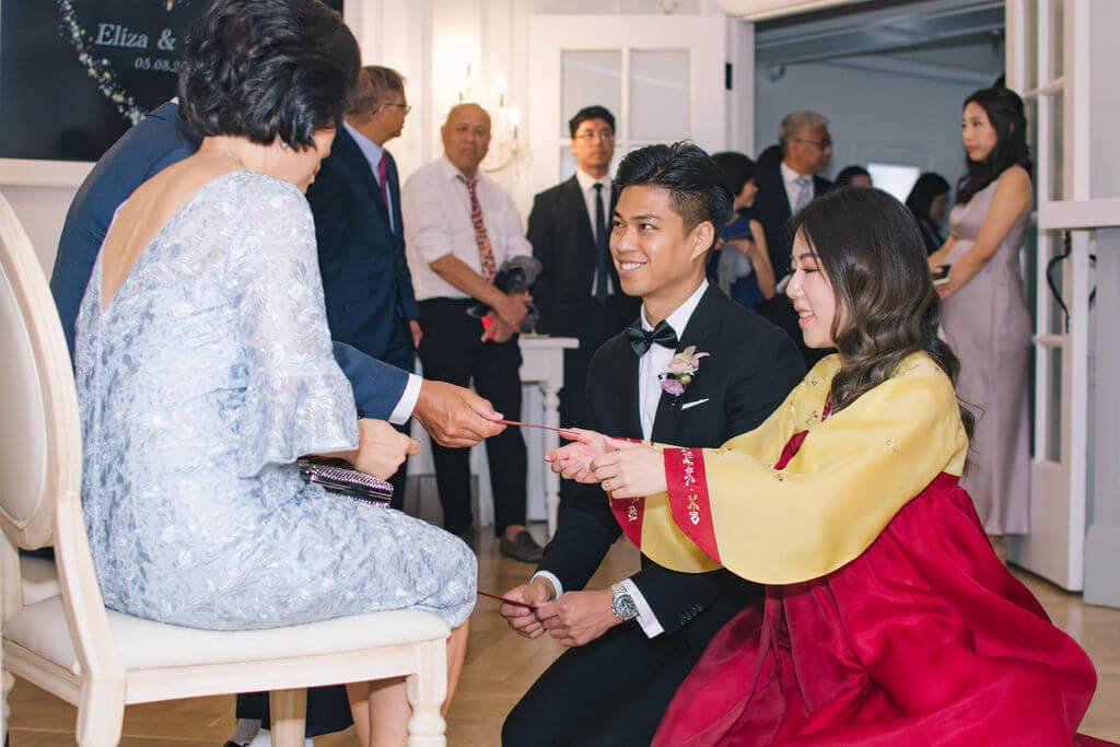Traditional tea ceremony during couple's chic summer wedding at The Doctor's House