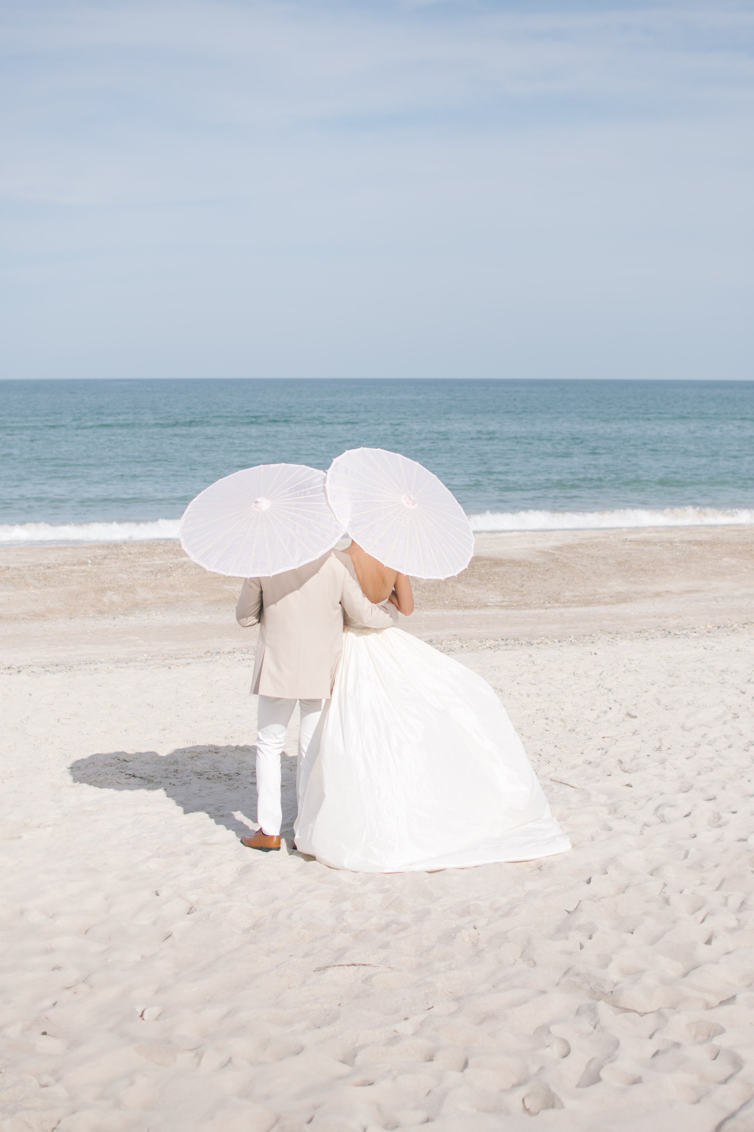 Romantic parasols for couple's destination beach wedding