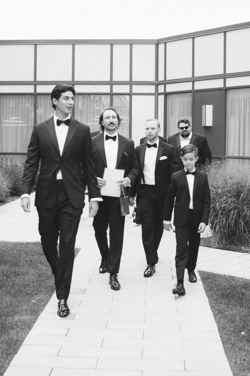 groomsmen-walking-with-groom-black-and-white-wedding