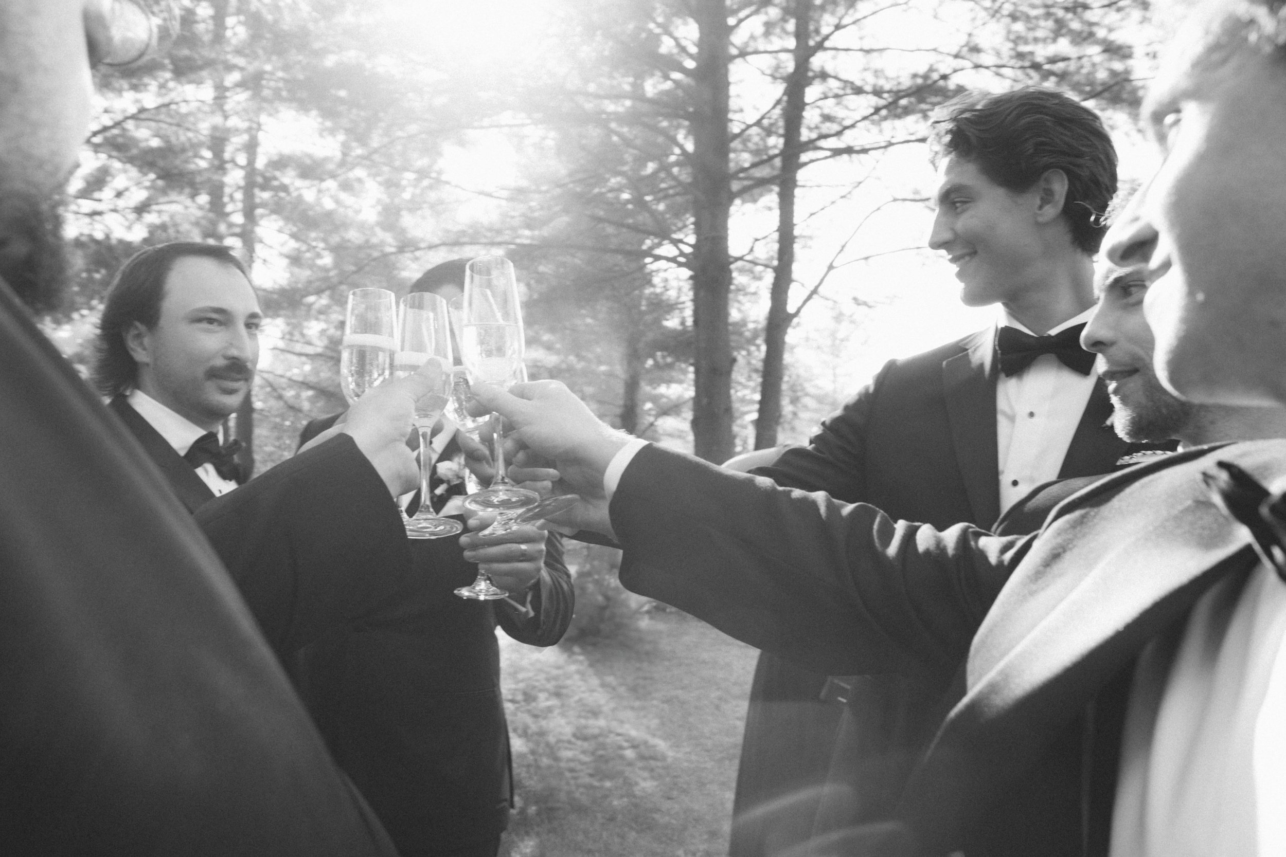 black-tie-groomsmen-champagne-toast-three-feathers-terrace