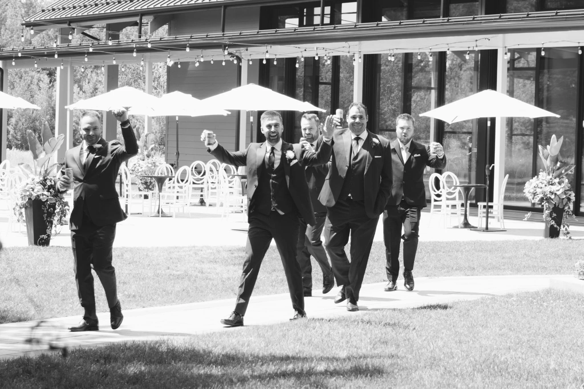 groomsmen-candid-walk-three-feathers-terrace-outdoor-patio