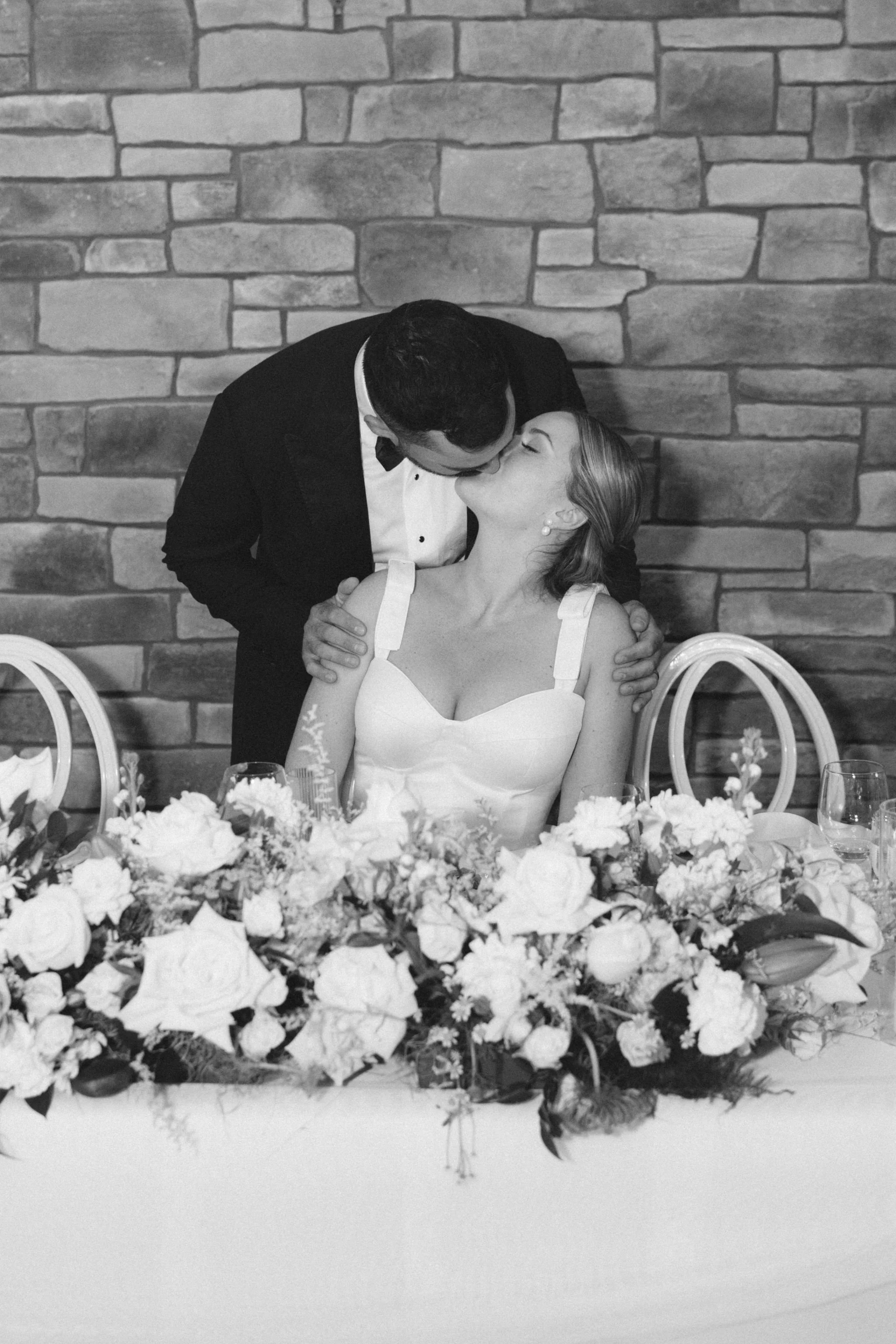 black-tie-wedding-sweetheart-table-stone-wall