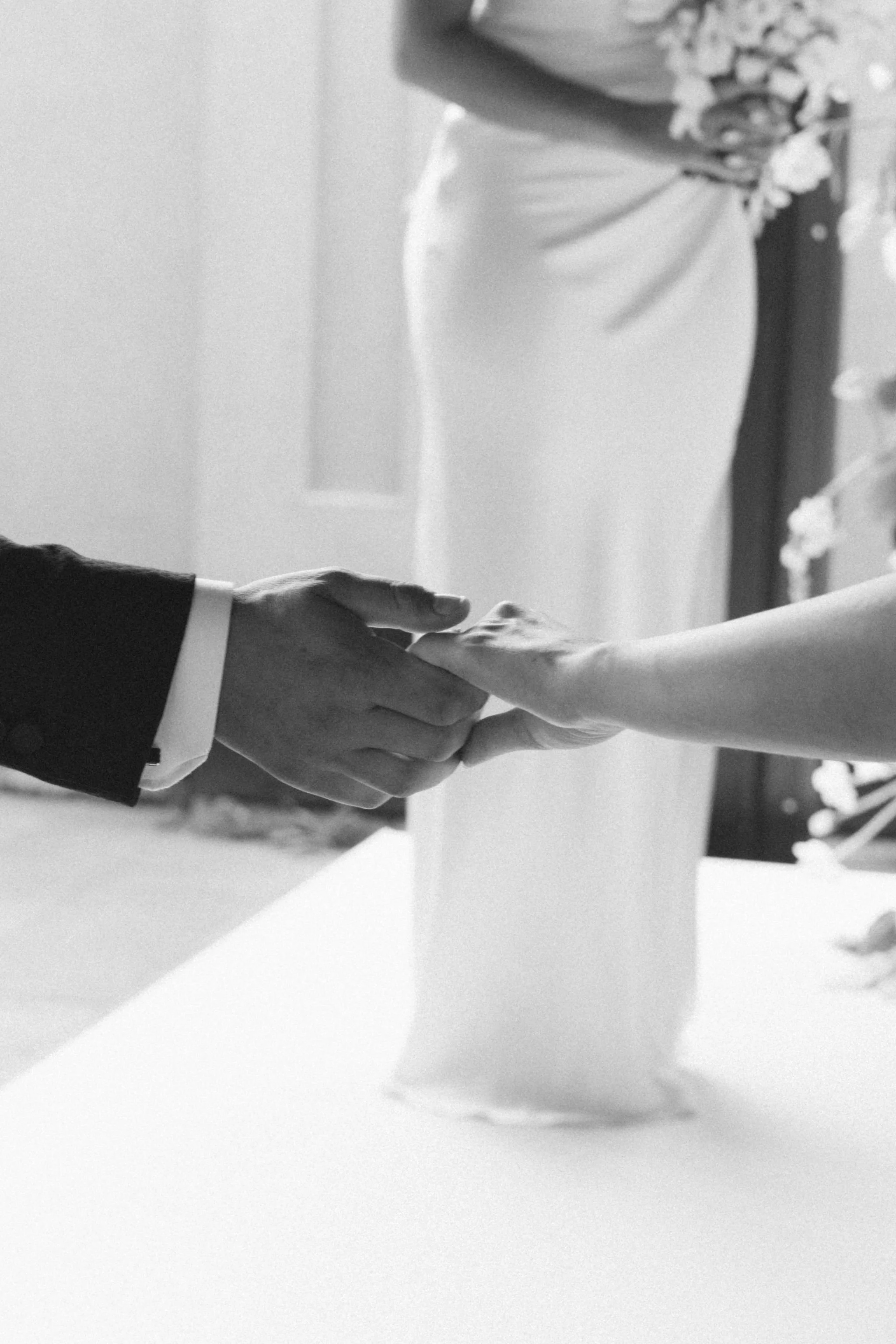 wedding-ring-detail-bride-and-groom-holding-hands