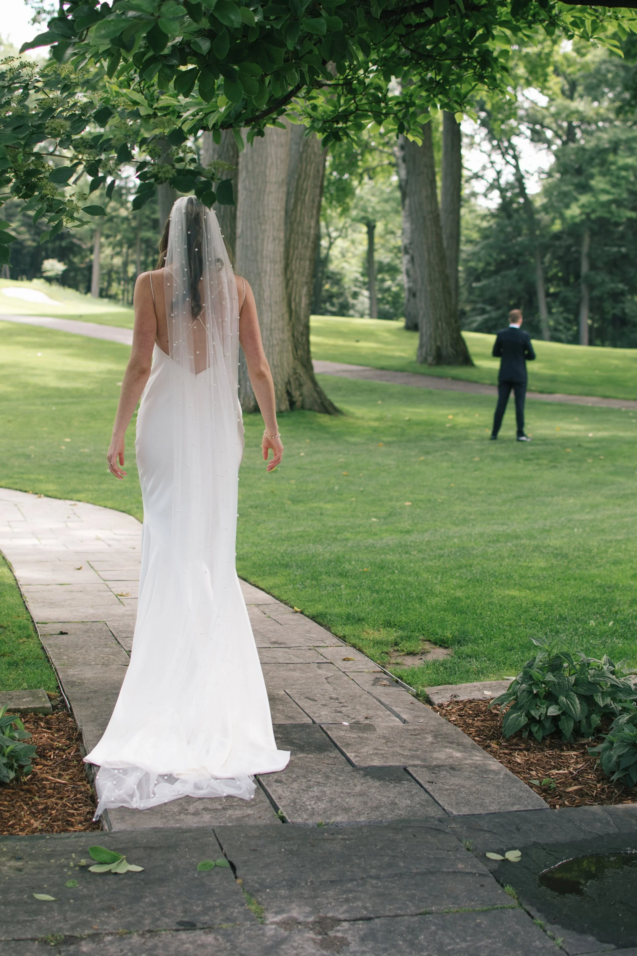 bride-walking-first-look-golf-club-wedding
