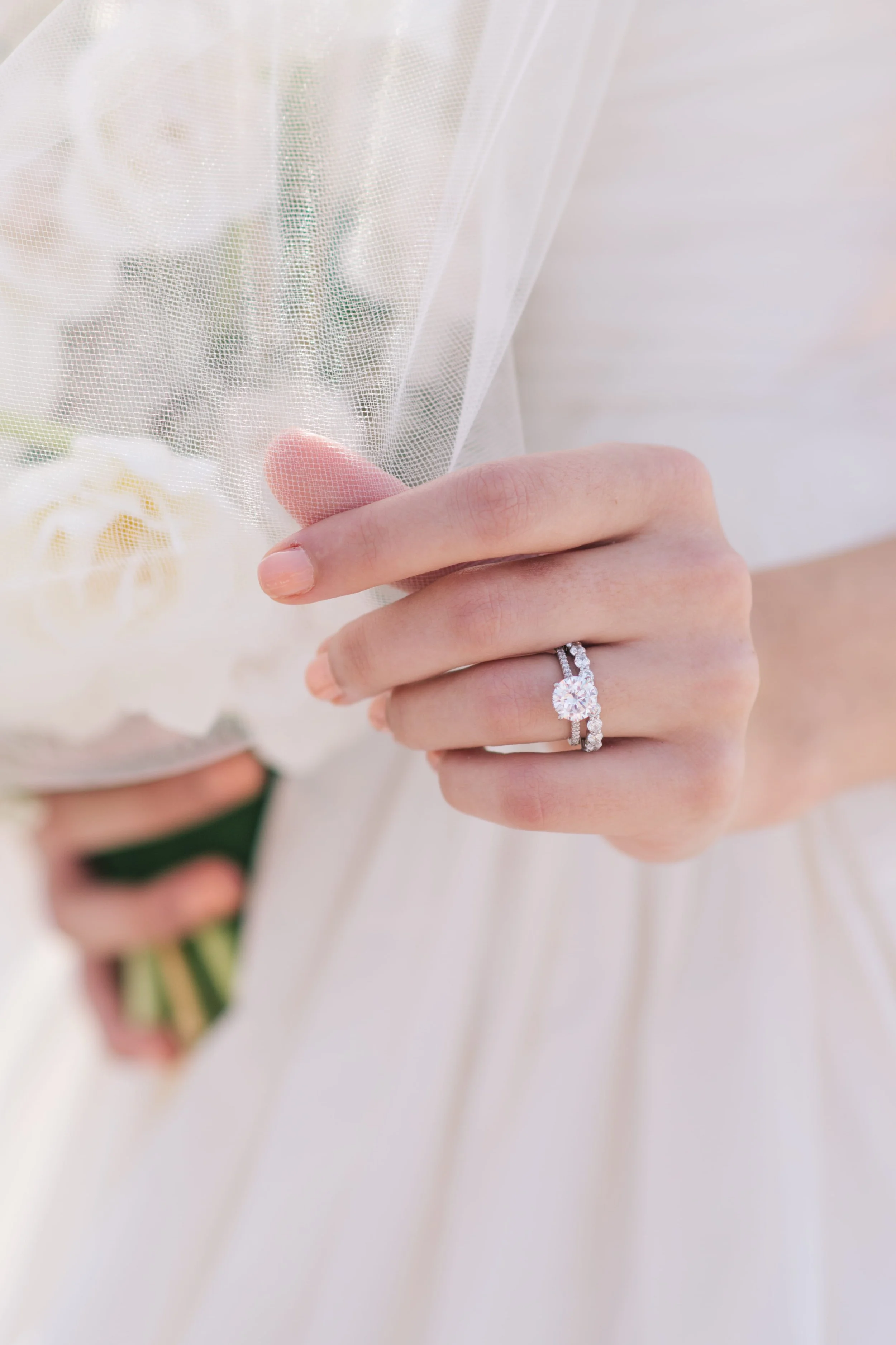 Wedding detail photo of engagement ring and veil photographed by fine art wedding photographers