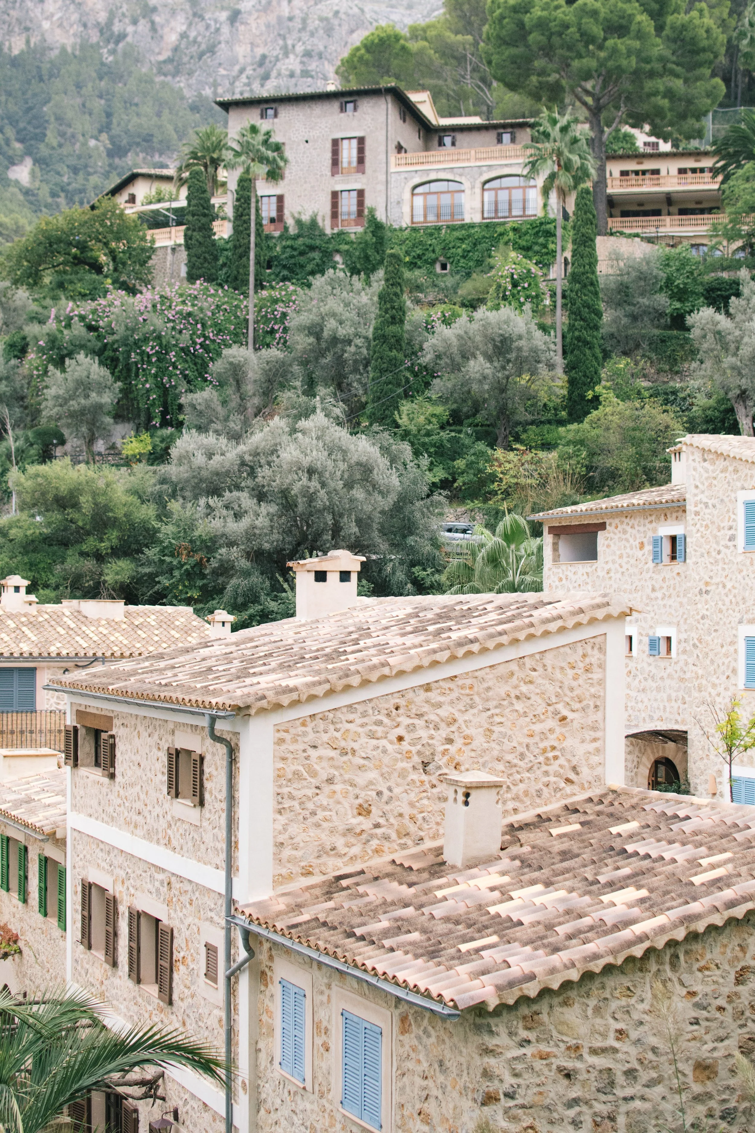 A scenic view of a luxury historic estate and stone villas in Mallorca, highlighting exclusive venue locations for a destination wedding.
