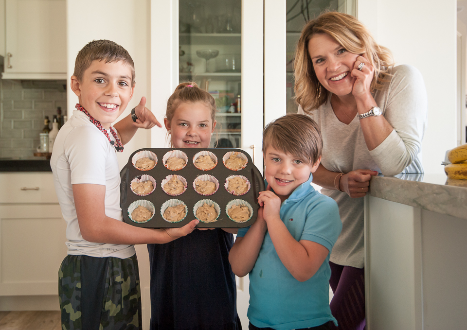 family showing muffins in pan
