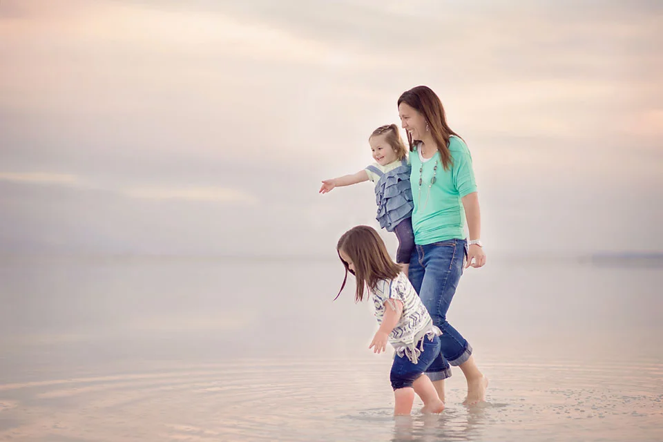 mom and daughters wading