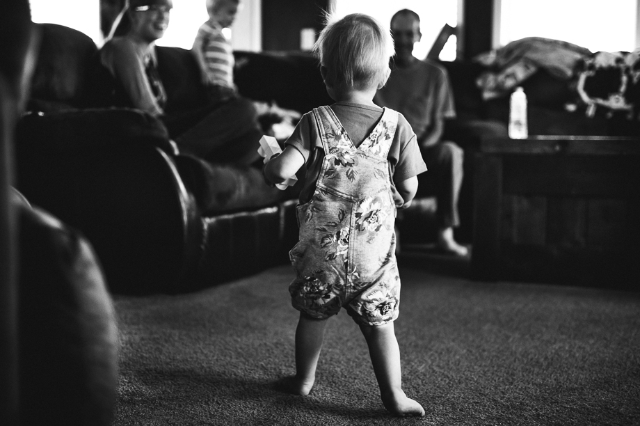 toddler running to happy family