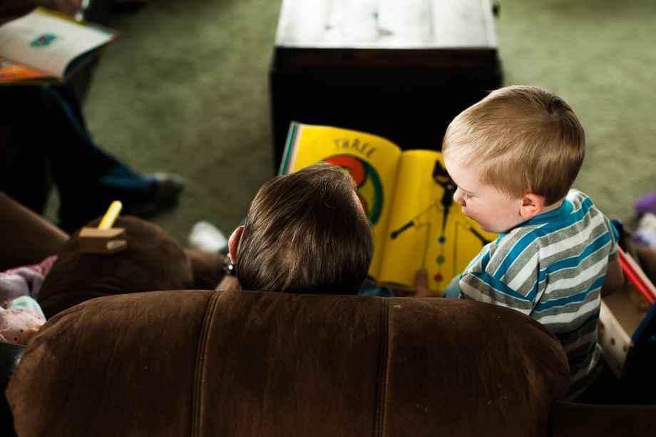 ariel view of man and boy reading at home