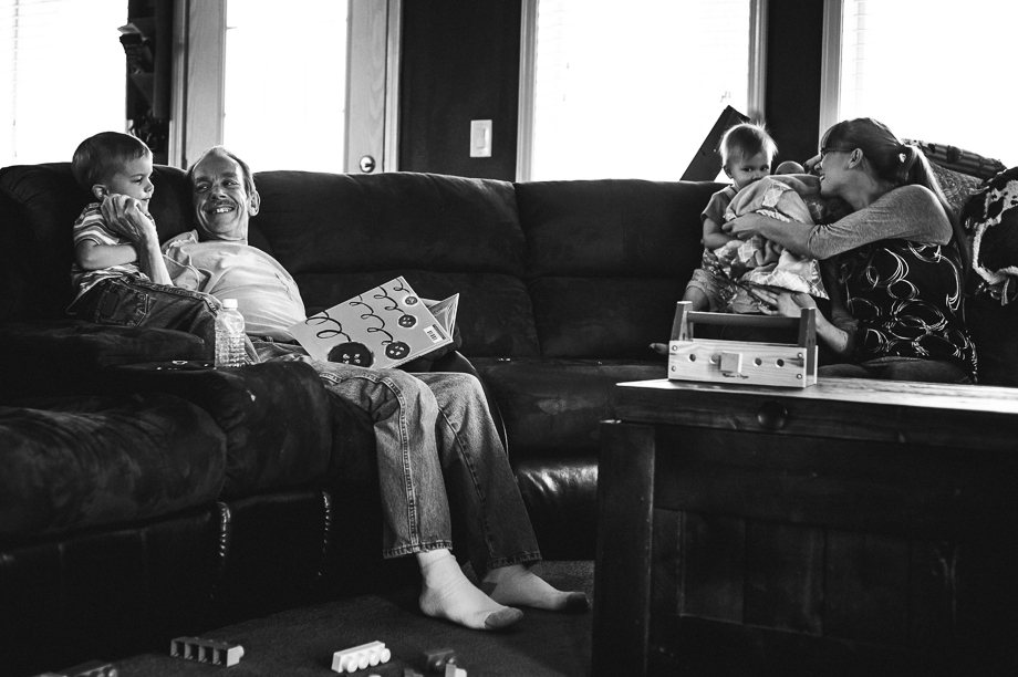 family reading and playing on couch