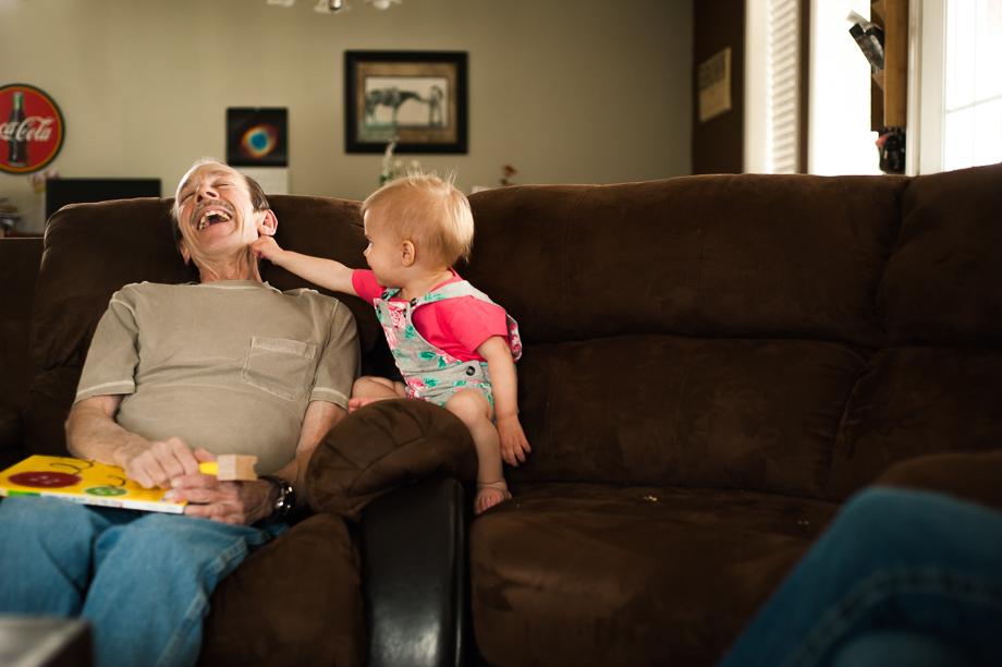 granddaughter tickling grandpa