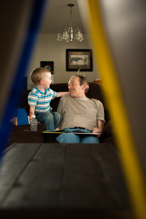 boy tickling grandpa