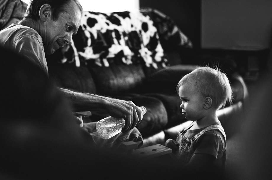 grandpa offering granddaughter drink