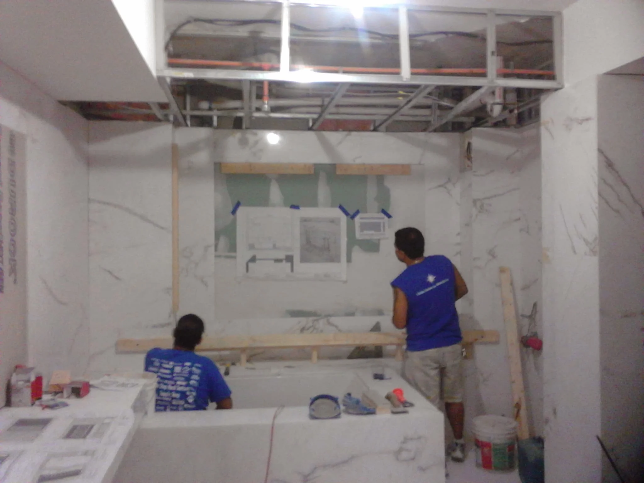  Floating 3D false wall with niche and rap around LED lighting. Material white vein marble 
