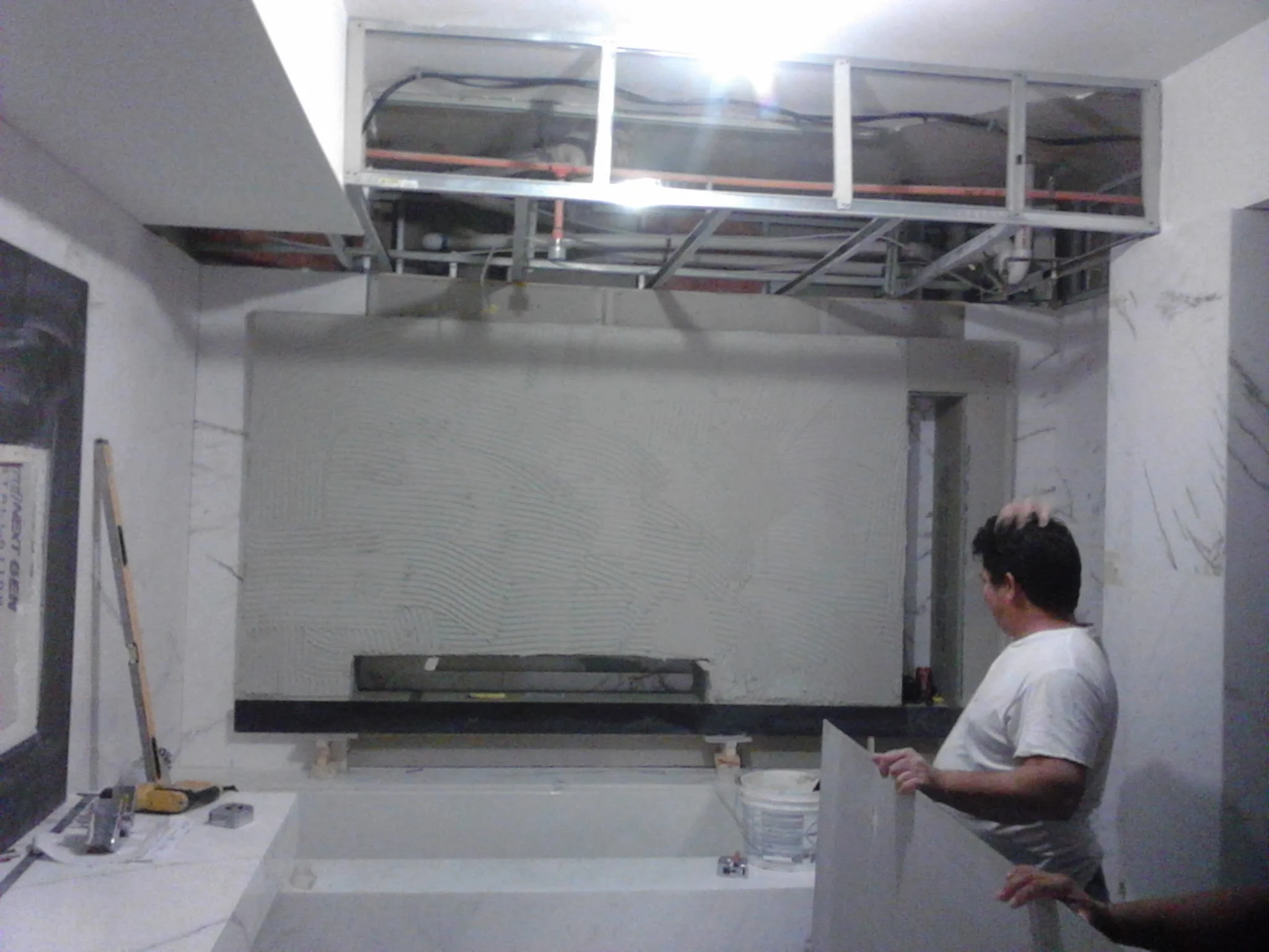  Floating 3D false wall with niche and rap around LED lighting. Material white vein marble 