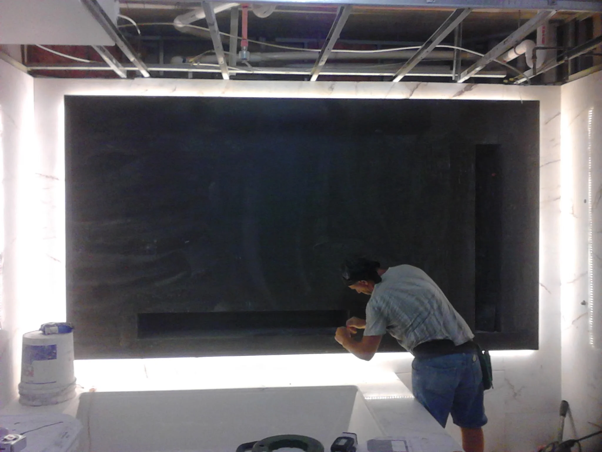  Floating 3D false wall with niche and rap around LED lighting. Material white vein marble 