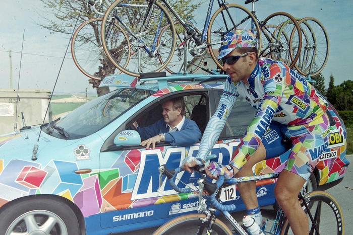 The late great Franco Ballerini alongside the Mapei team car