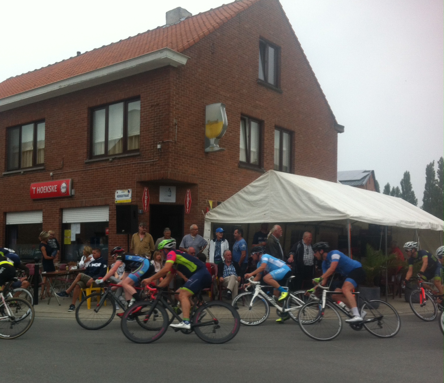 Conor passing the 'T Hoekske Pub before the Bazel finishing straight. Serves a great Westmalle Triple ...