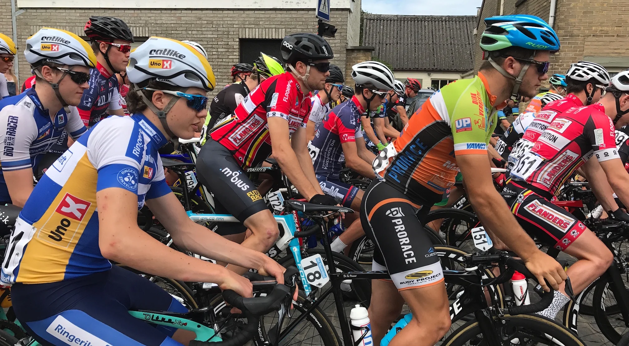 Tour of East Flanders 17 Stage 1 - 180 starters across 27 teams over 150k meant the first hour was utterly chaotic. There were narrow concrete roads, numerous bits of road furniture, stress levels off the scale, 5 major crashes and an average speed of 45+ kph. Peter (in red Flanders jersey above in centre of shot) finished 80th safely in the peloton in a dangerous bunch kick. Peter was the only Flanders team rider to finish in the peloton and for the rest it was carnage. Except for Peter the Flanders team had a totally forgettable day with three non finishers and it would have been a fourth save for some supportive commissaires. 