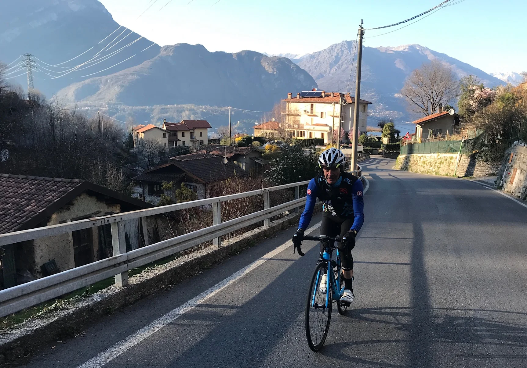 IL Perlo Hotel @ 20 Mar - Mike Lawson heads off up the Ghisallo climb with the IL Perlo Hotel soaked in the afternoon sunshine