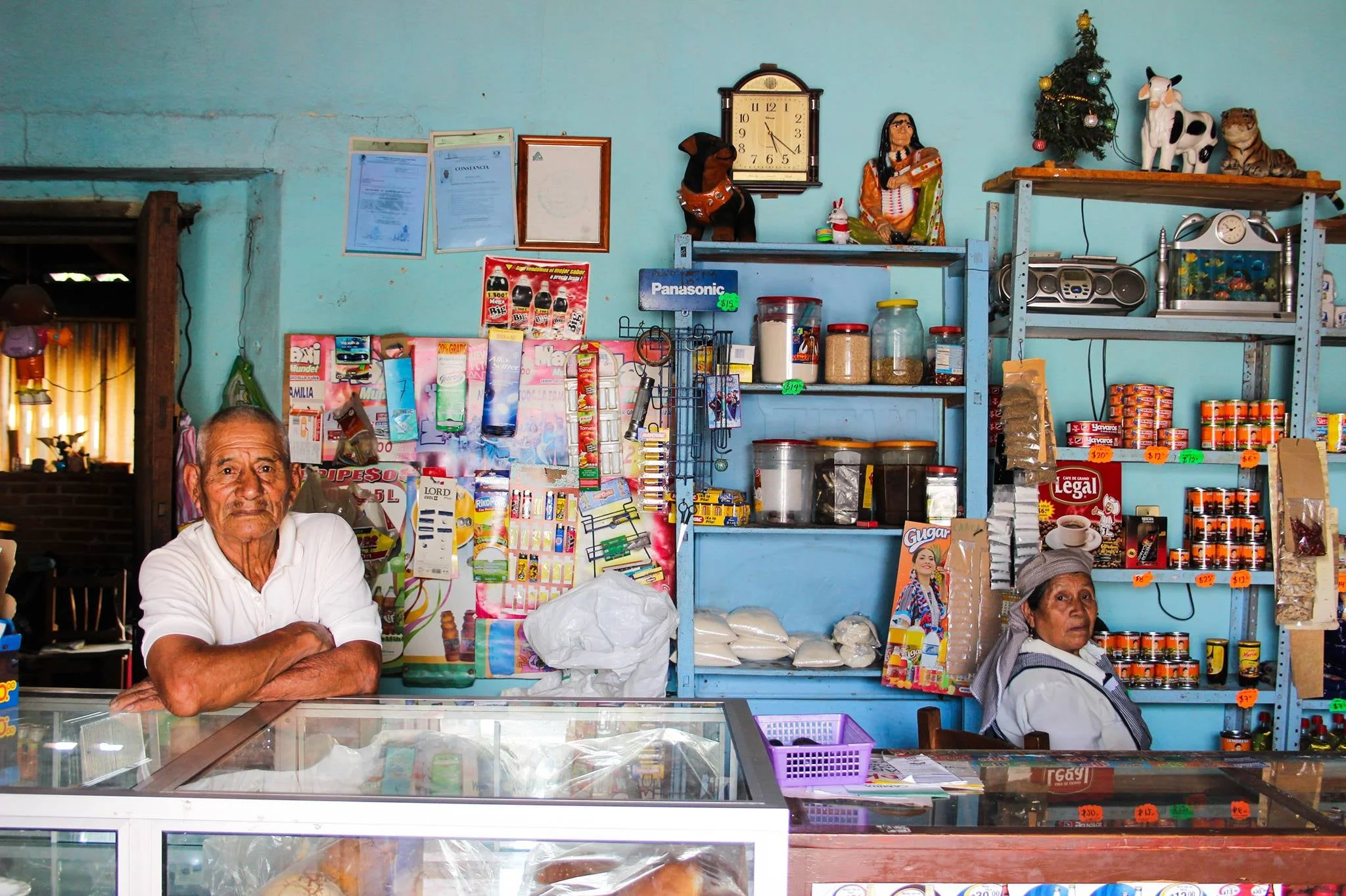 A couple attend their shop in the outskirts of Oaxaca City, Mexico. In their 80s, they grew up, met and married in the same small town.