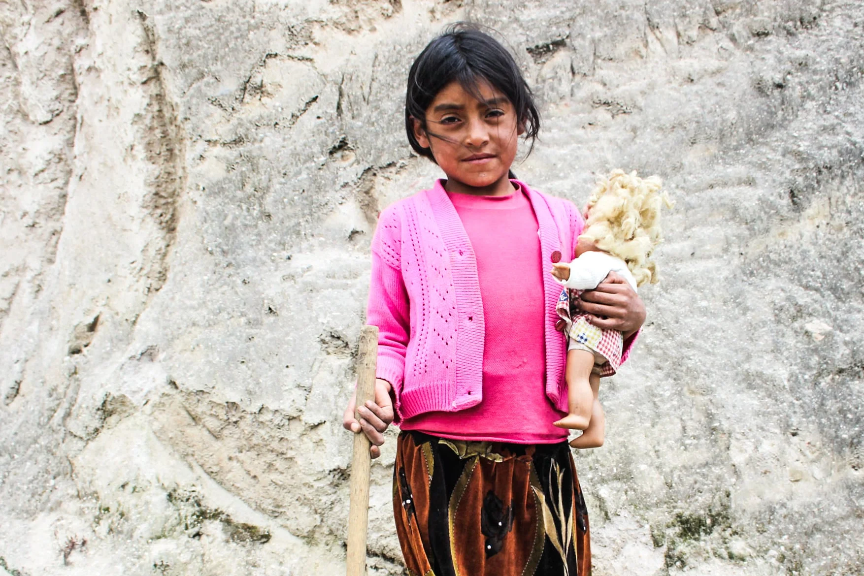 Girl with a farming tool and a doll in a rural village near Chugchilán, Ecuador. Many poor parents do not send their children to secondary school due to costs and children in school who are not able to contribute to family income. Of the children (ages 5 to 17) involved in child labor, 24.9% do not attend school. Statistics worsen with ethnicity and higher levels of education: 48% of indigeno us adolescents do not attend secondary school in rural areas, and 37 to 40% do not attend secondary school in urban areas. However, overall social welfare statistics are improving and many attribute this to policy reform. In 2015, 22.5% of the nation lives below the poverty line. This is a drop of 10% since 2010. 