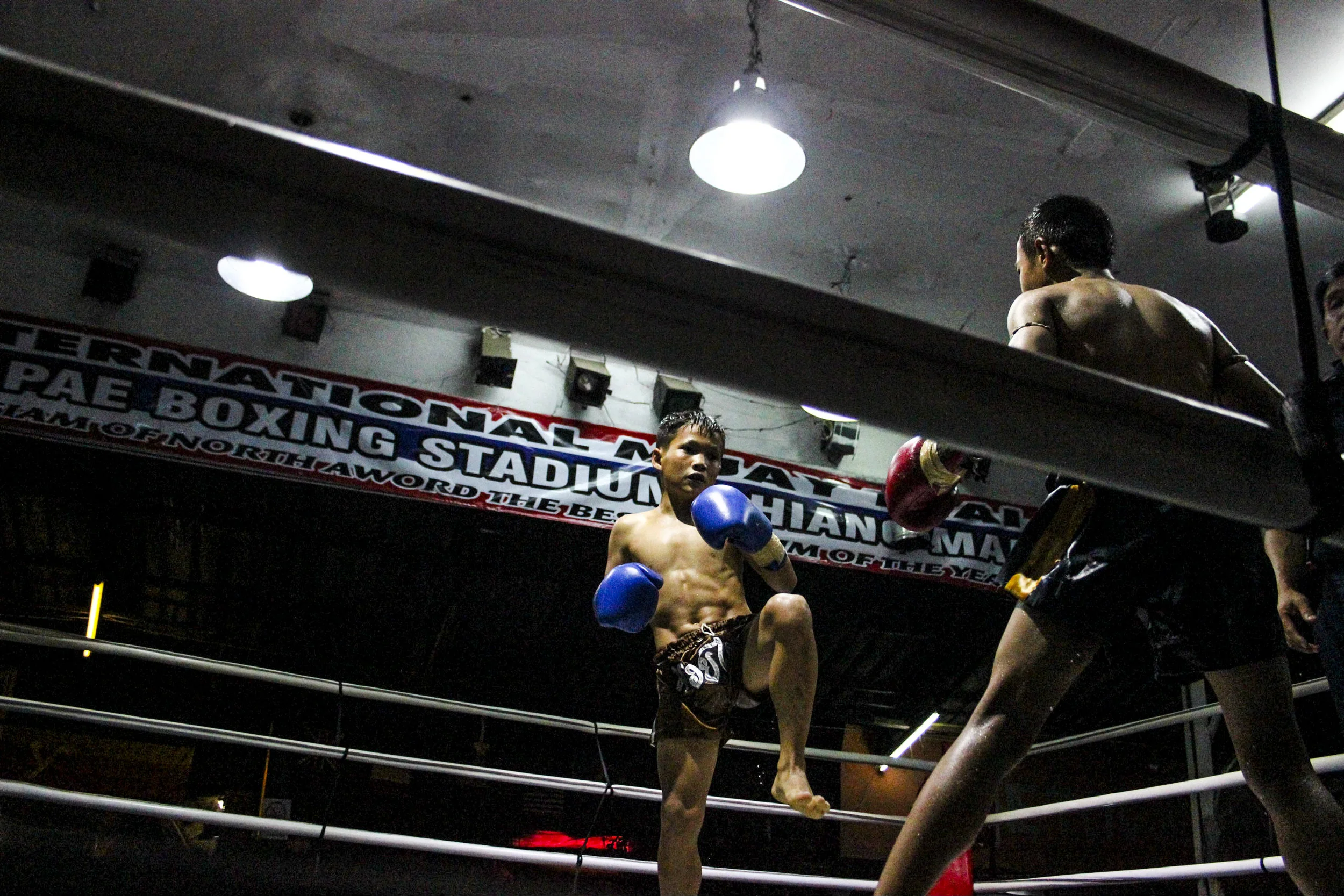 The young boy fights his opponent. Children train up to five days a week, their gyms becoming a second home. 