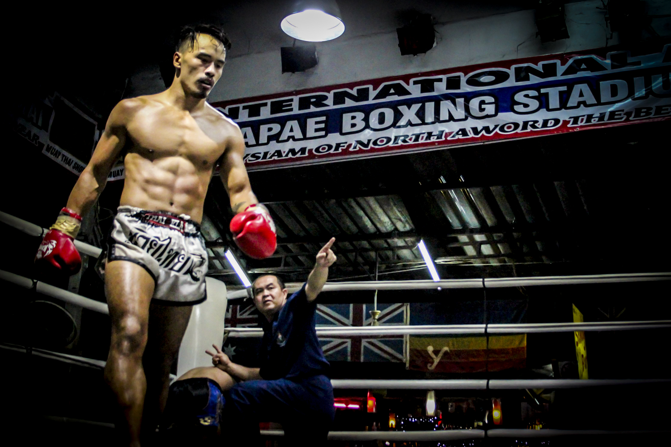 Richy knocks his opponent to the ground, winning the match. 