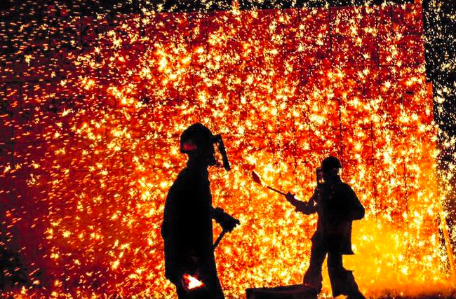 Artists during a giant iron pour. 
