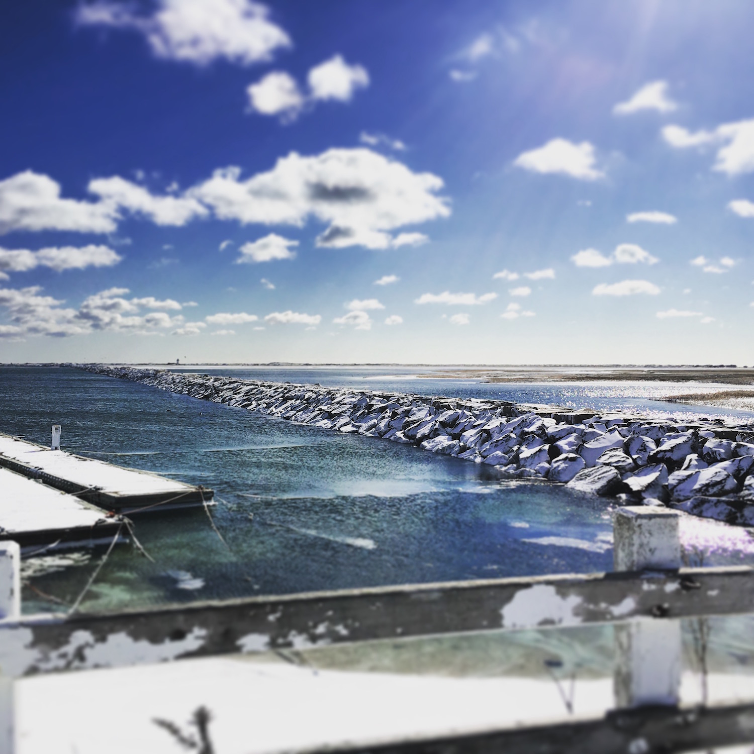 The Provincetown Inn at what feels like the end of the Earth, looking across the harbor at a snowy breakwater.