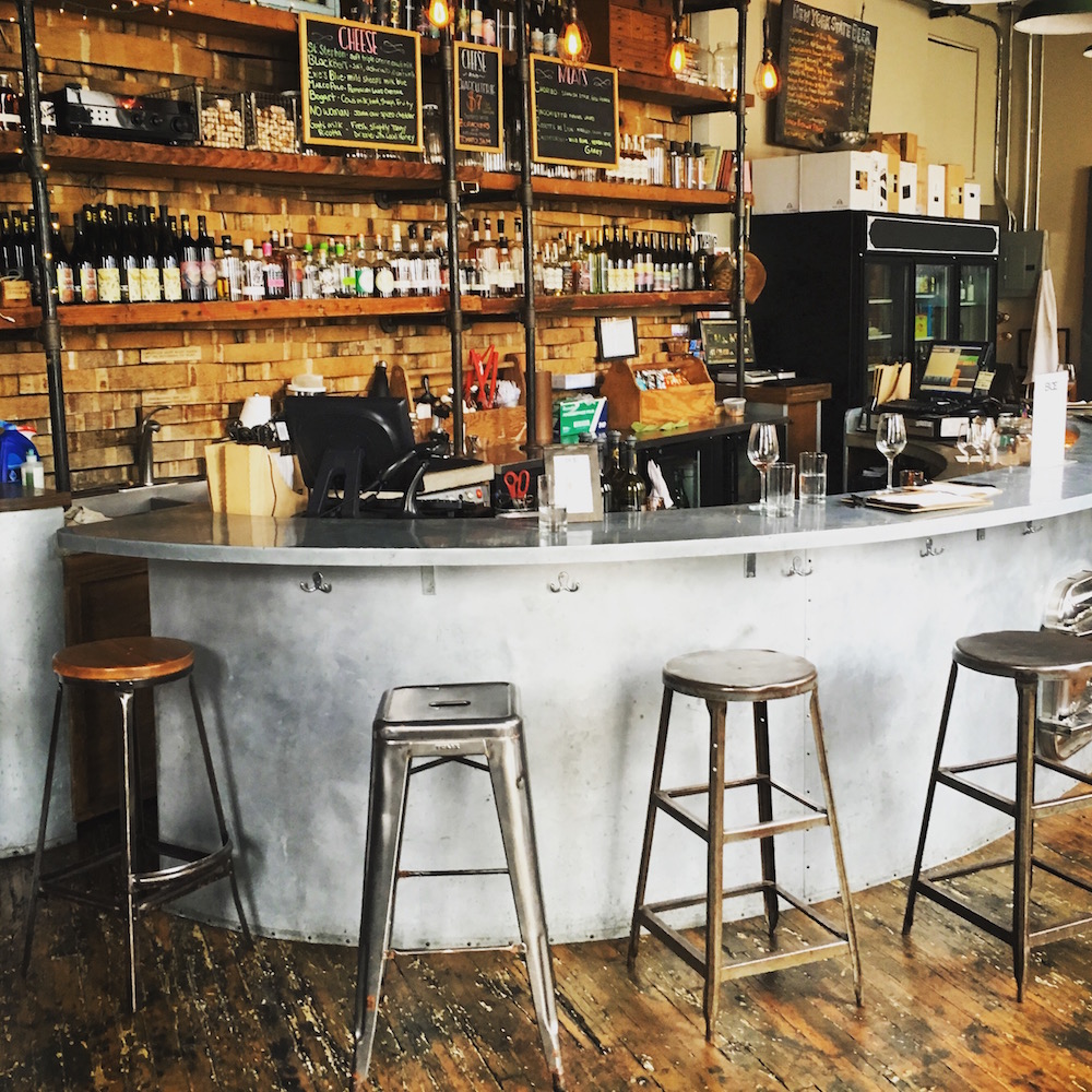 Each their unique sense of place. The bar at Brooklyn Oenology welcomes visitors just the way you'd expect.