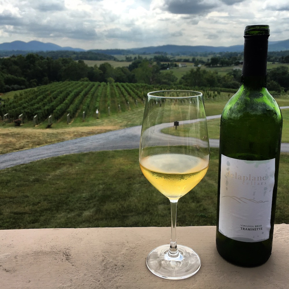 Taken from the deck at Delaplane Cellars in mid-September, we imagine that the world is turning autumn colors far as the eye can see at this point. Note the three distant peaks in the upper left, reproduced on the wine label in the bottom right.