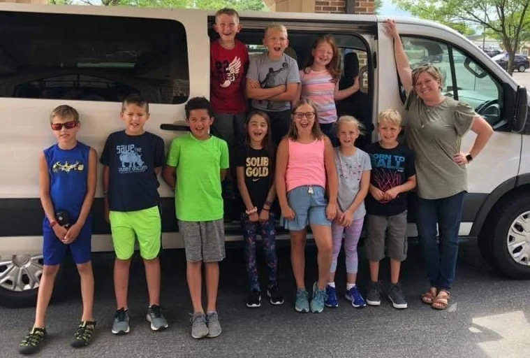 A group of excited campers head off to Joy Ranch