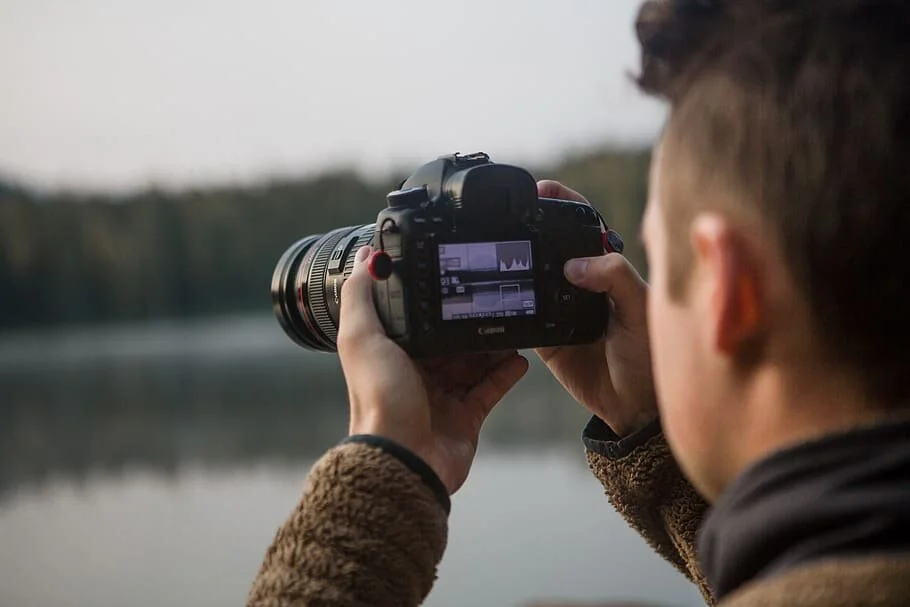 person-holding-black-dslr-camera.jpg